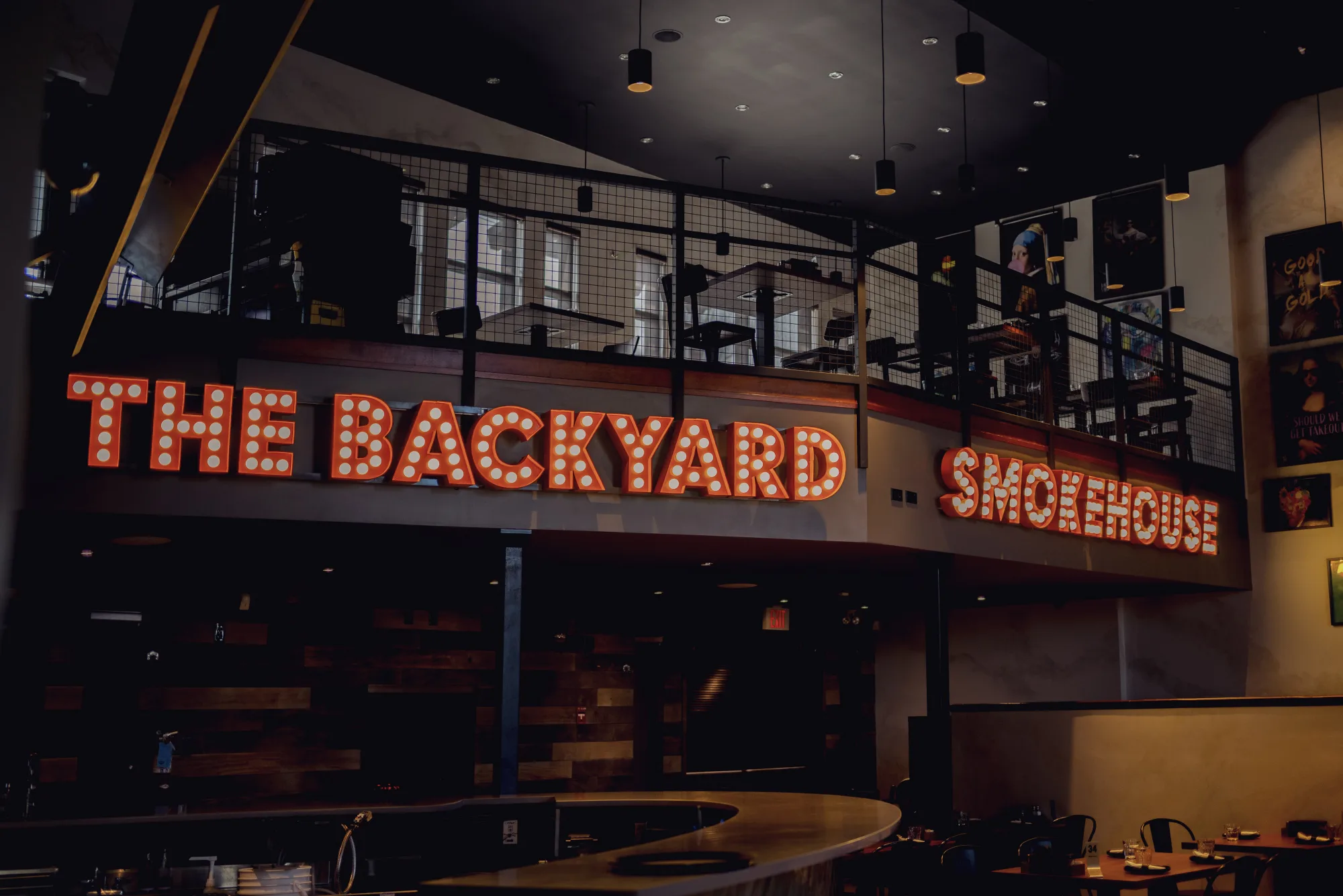 Illuminated marquee sign and two-level dining room at Backyard Smokehouse Edmonton