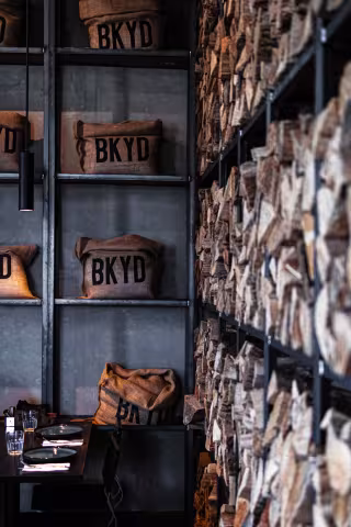 BKYD branded burlap bags lining the wall at Backyard Smokehouse Mississauga