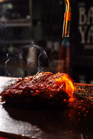 Freshly smoked BBQ ribs glazed and steaming at Backyard Smokehouse Mississauga