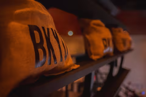 Backyard Smokehouse Edmonton BKYD branded burlap bags lined up on shelf in restaurant